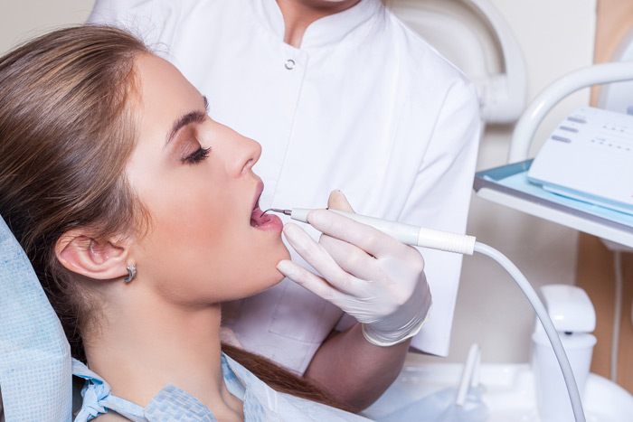 woman at the dentist receiving local anesthetics